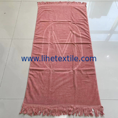 China OEM custom luxury 100% cotton plain embossed  logo design beach towel with tassel supplier