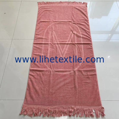 OEM custom luxury 100% cotton plain embossed  logo design beach towel with tassel supplier